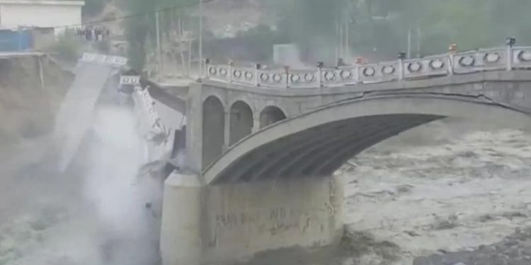 The crumbling Hasanabad bridge due to a massive GLOF